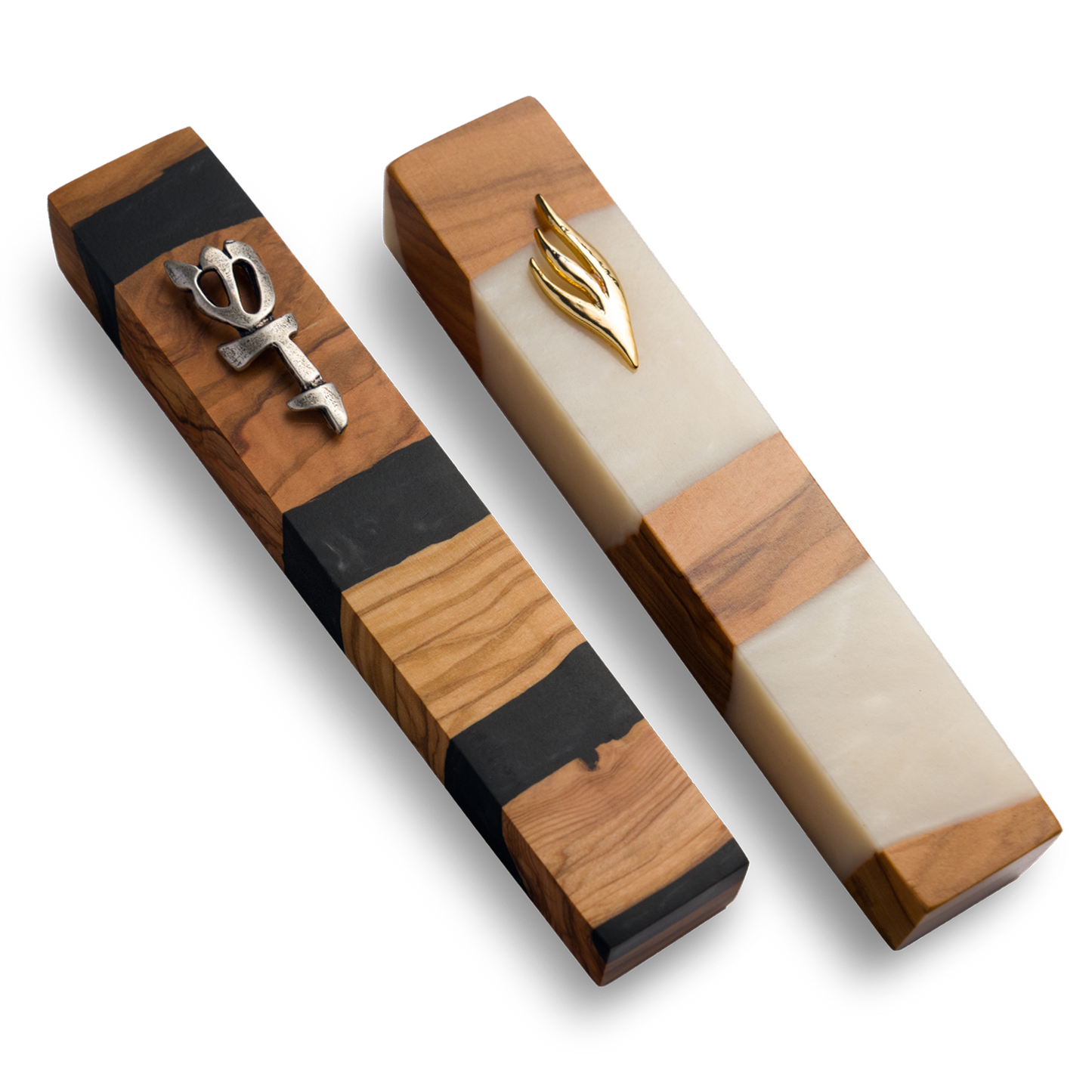 Handmade mezuzahs crafted from olive wood in black and white resin, featuring a silver and gold Shin symbol on the front.