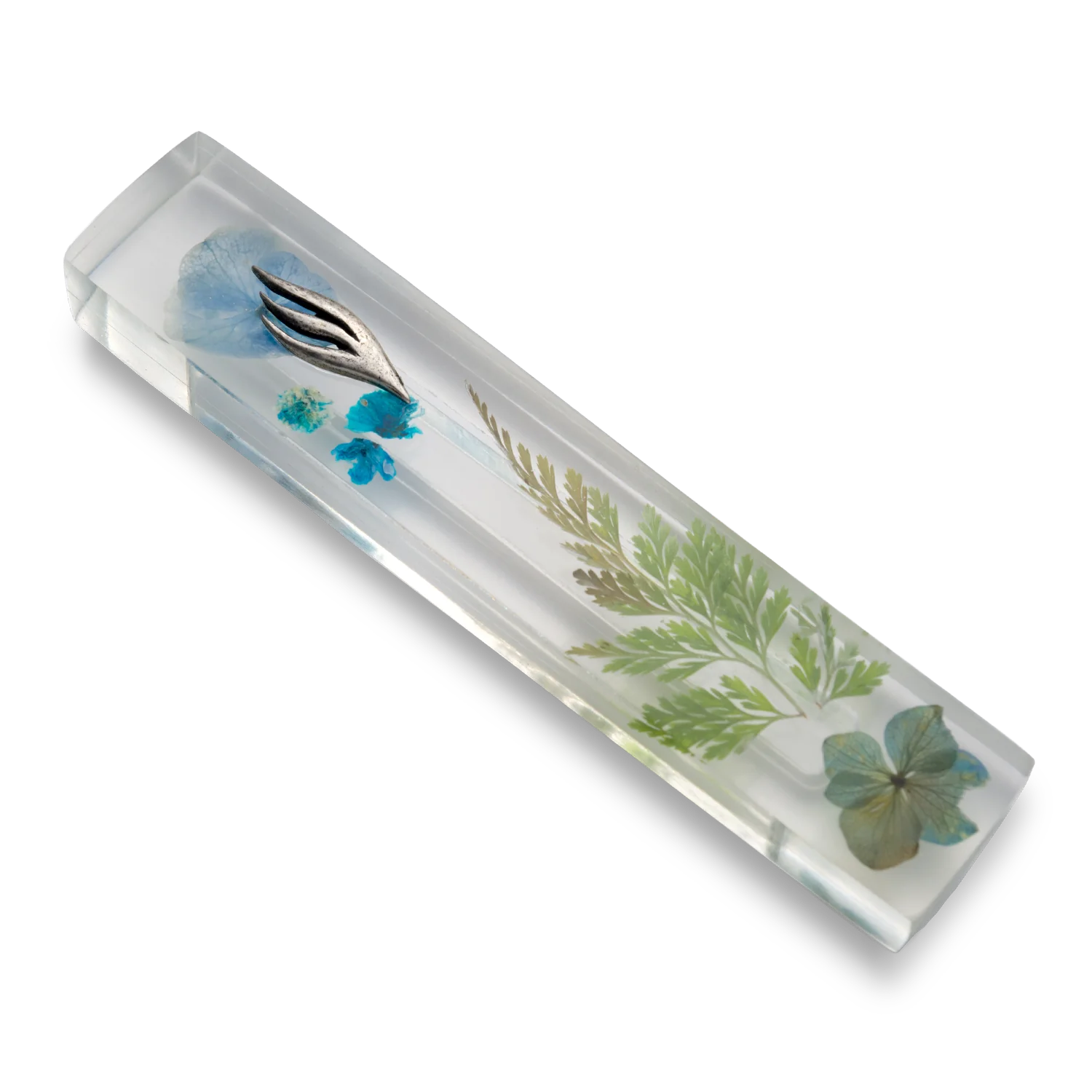 Handmade mezuzah crafted from clear resin and blue preserved flowers, featuring a silver Shin symbol on the front.