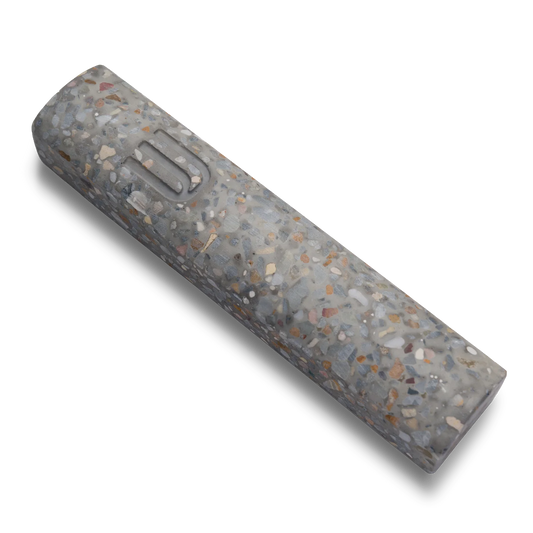 Handmade mezuzah crafted from marbled concrete, featuring Shin symbol on the front.