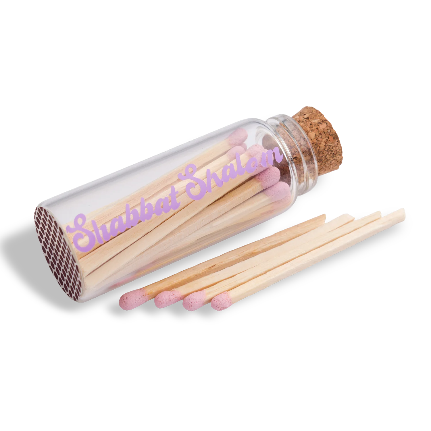 Handmade glass jar with cork lid filled with pink-tipped matches, labeled “Shabbat Shalom” 