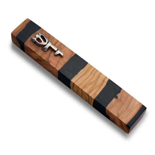 Handmade mezuzah crafted from olive wood and black resin, featuring a silver Shin symbol on the front.