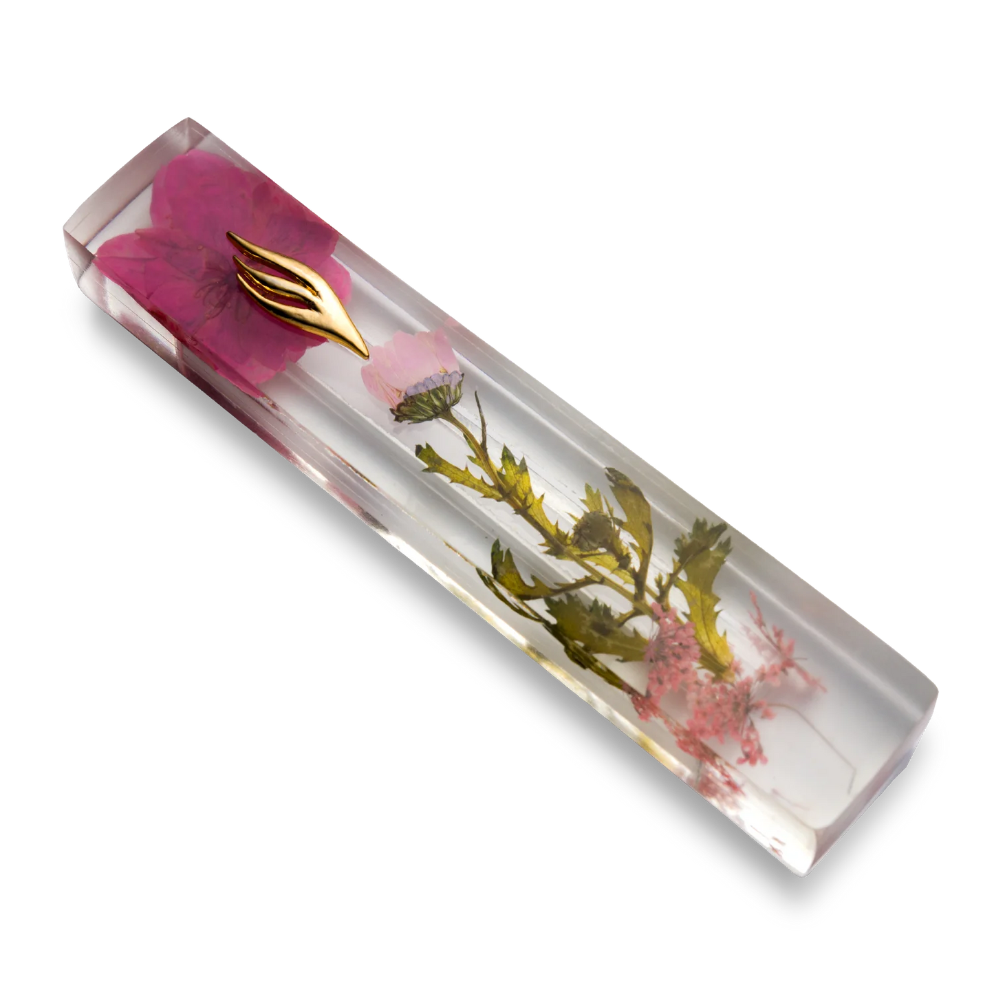 Handmade mezuzah crafted from clear resin and pink preserved flowers, featuring a golden Shin symbol on the front.