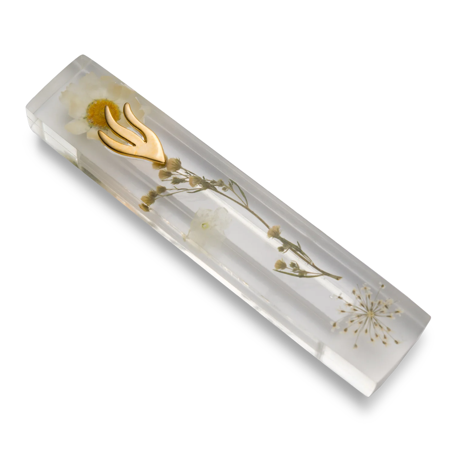 Handmade mezuzah crafted from clear resin and white preserved flowers, featuring a golden Shin symbol on the front.