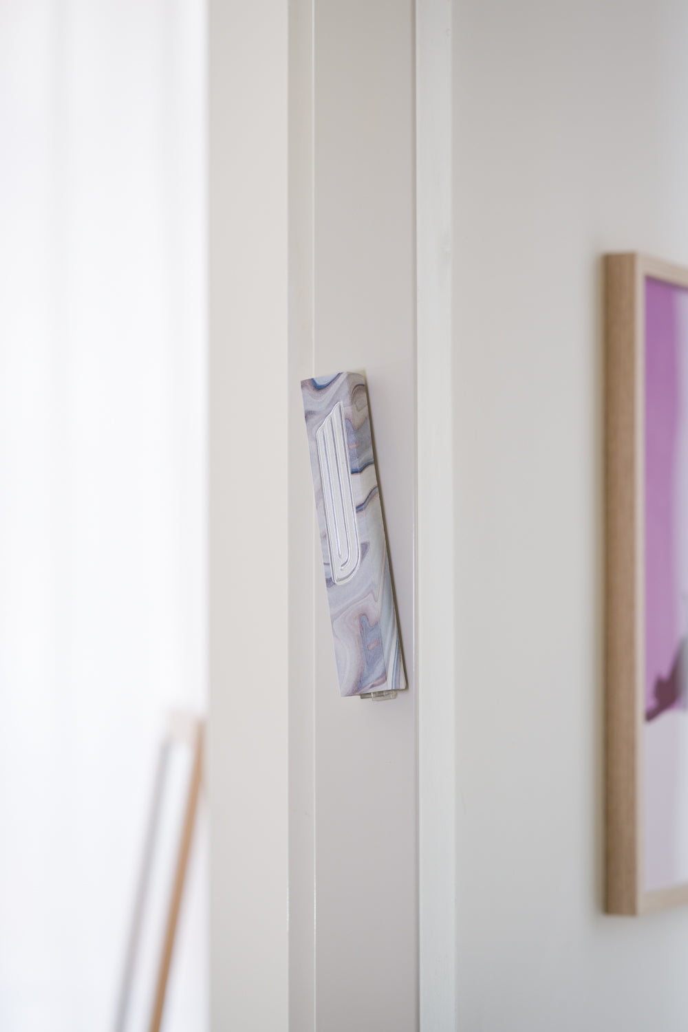 Handmade concrete grey mezuzah case on a doorpost, placed by the Jewish tradition.