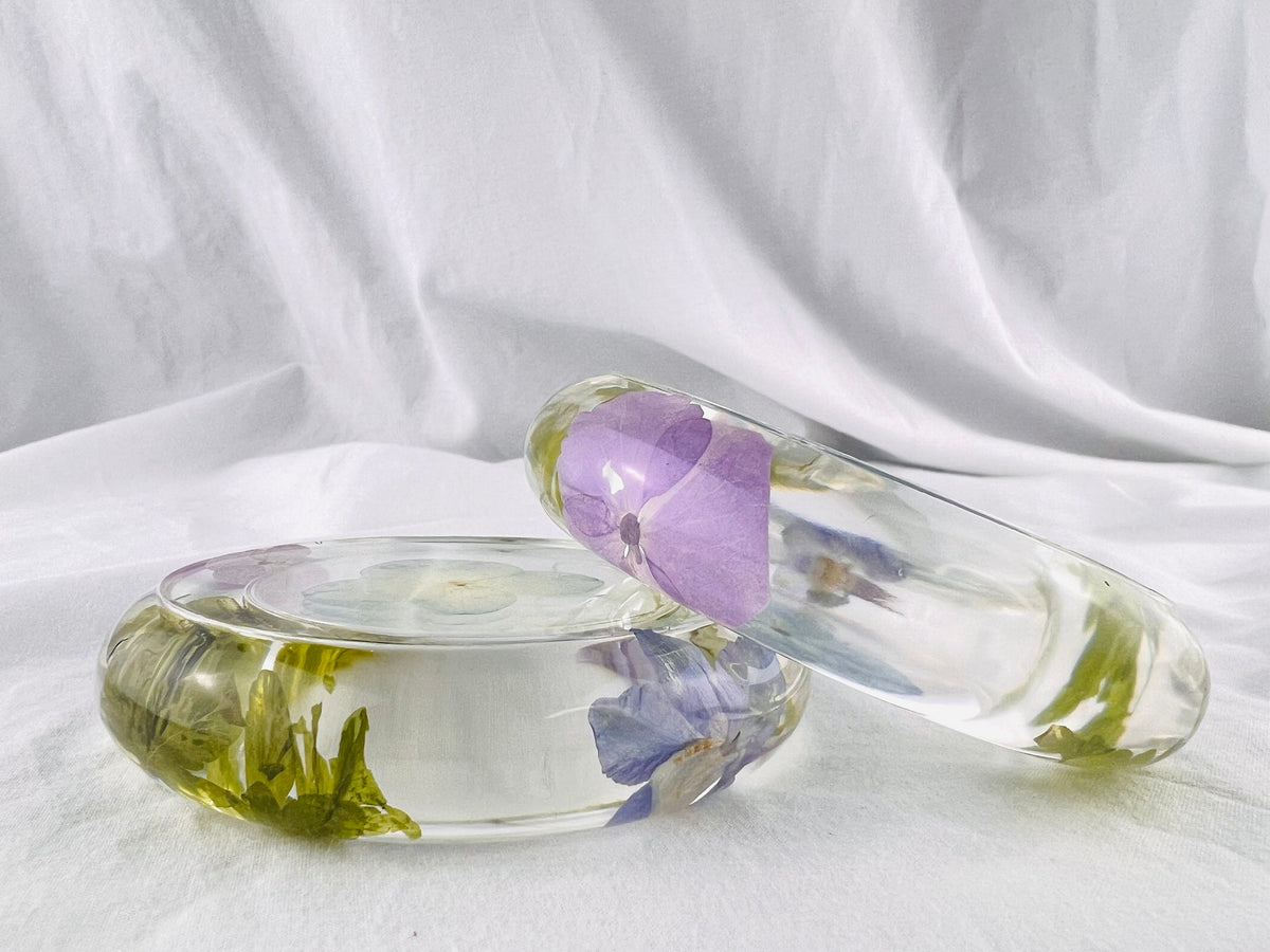 Handmade floral resin tealight holder with a lit candle