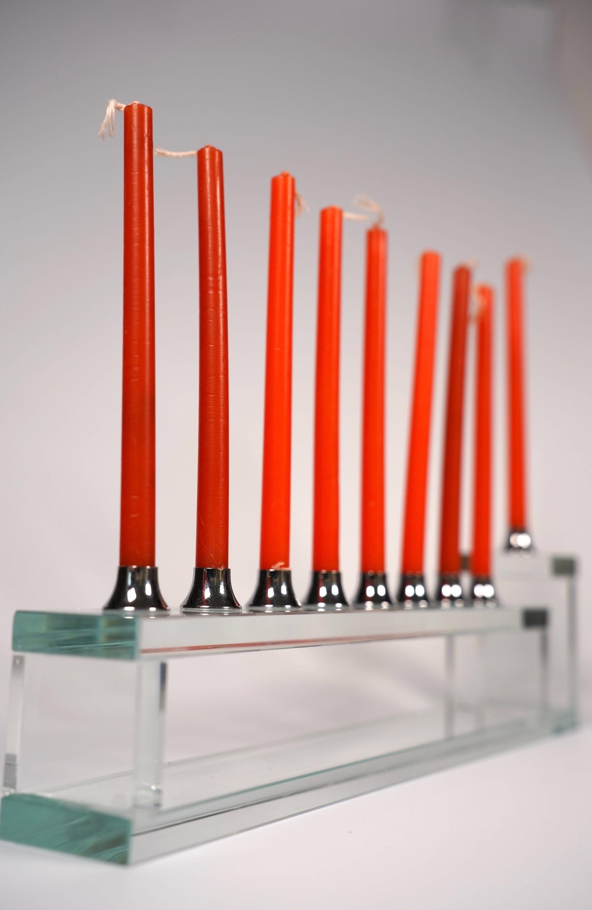 Handmade glass hanukkiah with candles lit