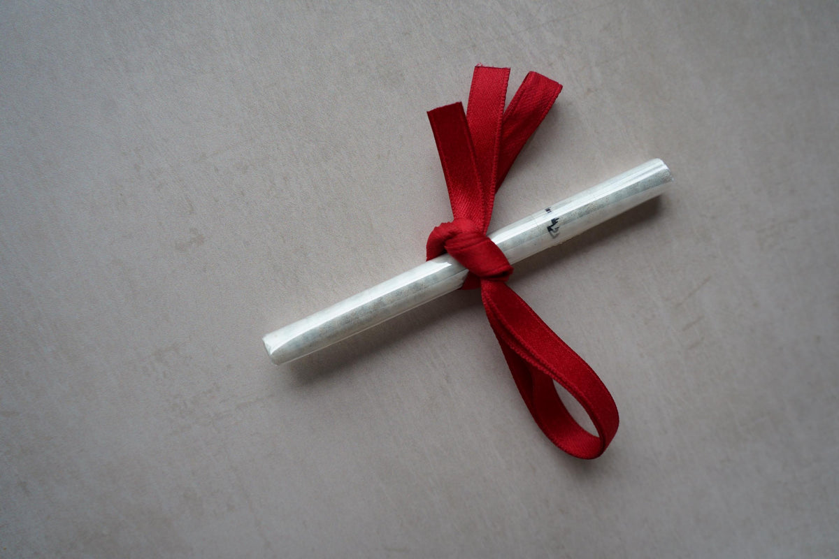 Kosher mezuzah scroll in its protective sleeve