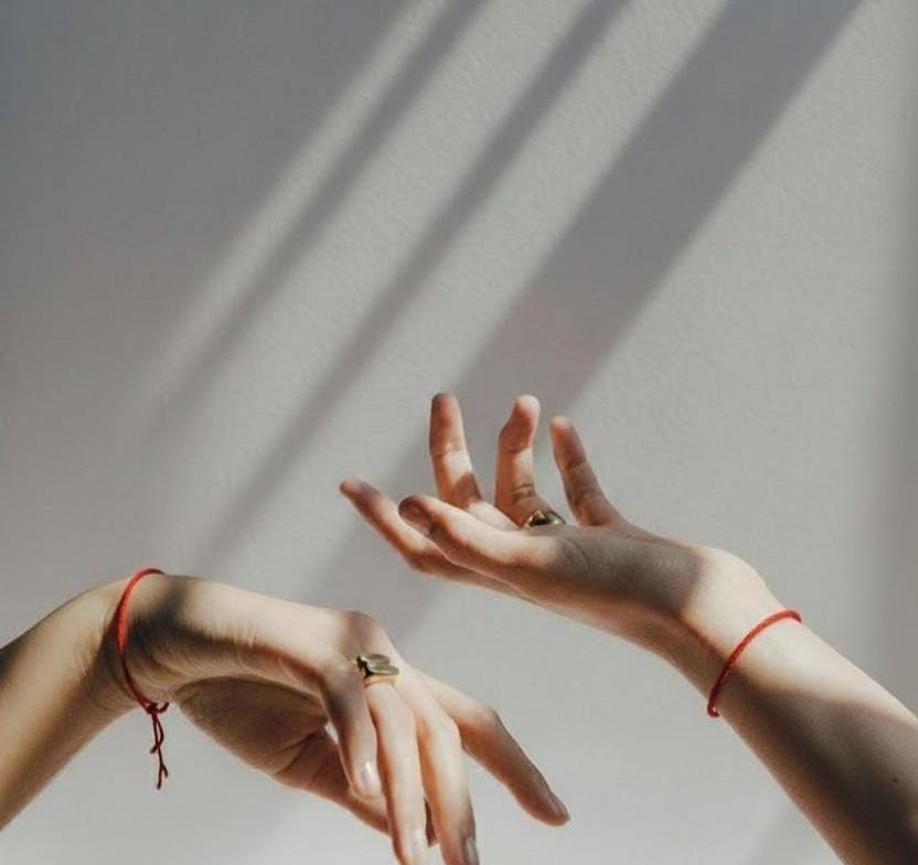 Red string bracelet tied on a wrist